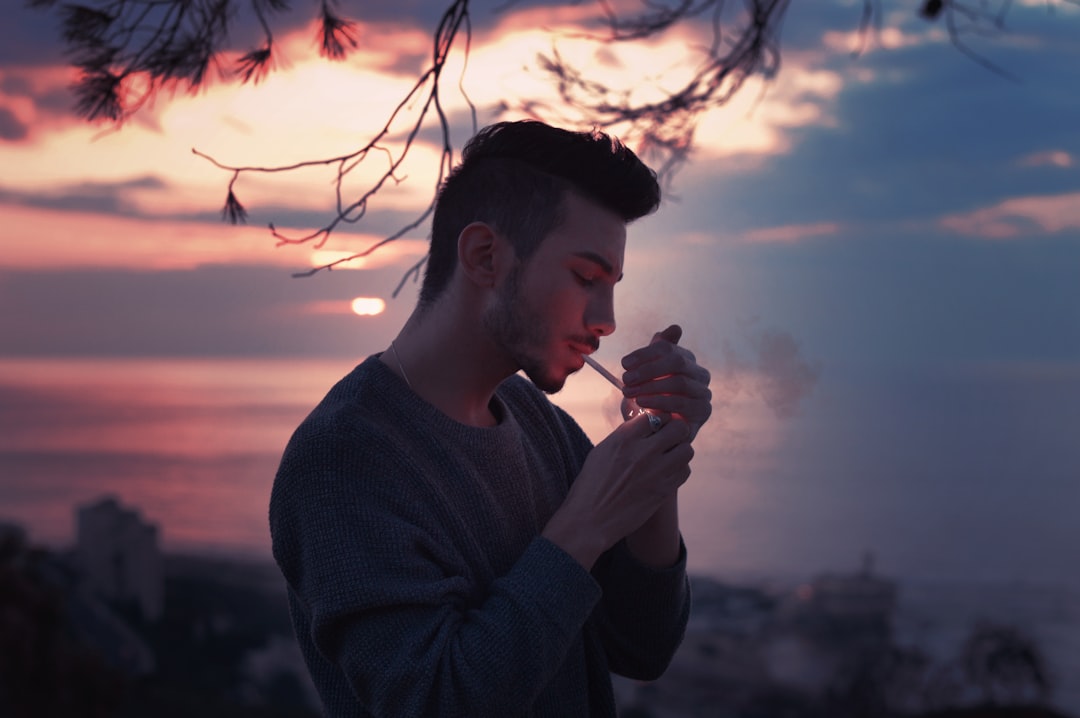 man smoking white holding lighter