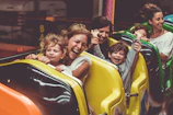 Close-up of happy kids enjoying a roller coaster ride at Universal Studios.