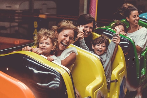 Teenagers enjoying a thrilling ride together at a Disney theme park, their faces lit with joy and excitement.