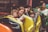 A happy family enjoying a theme park ride together, smiling and having fun.