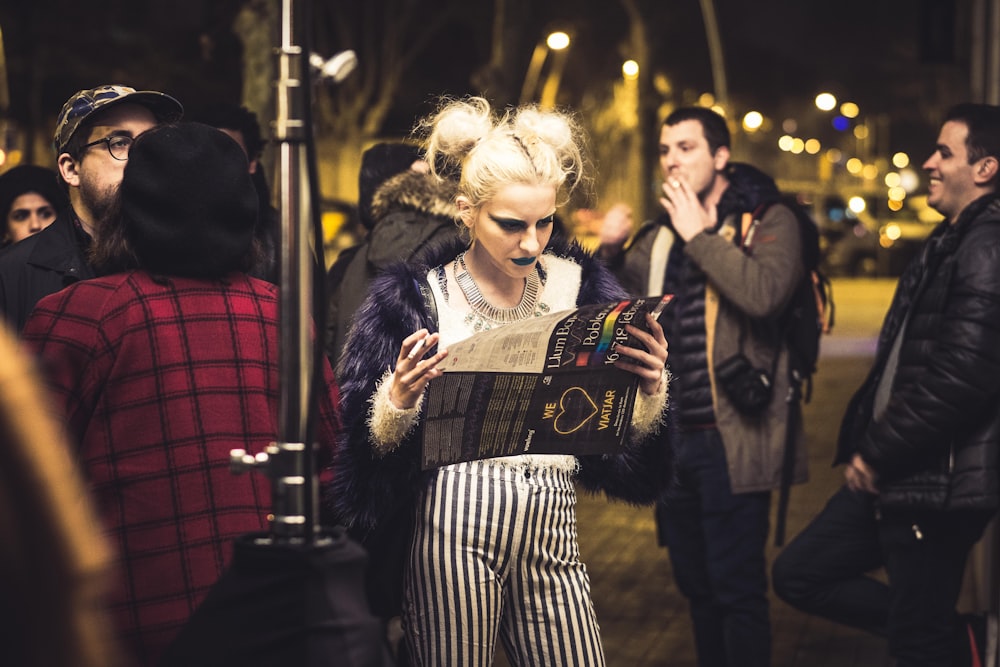 woman holding magazine