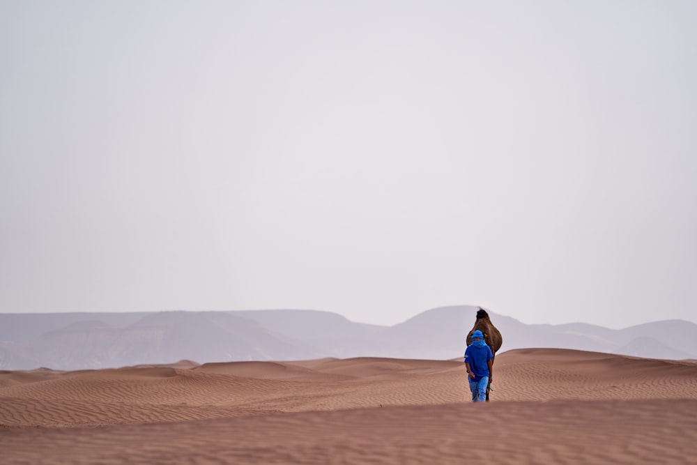 standing person on sand during daytime