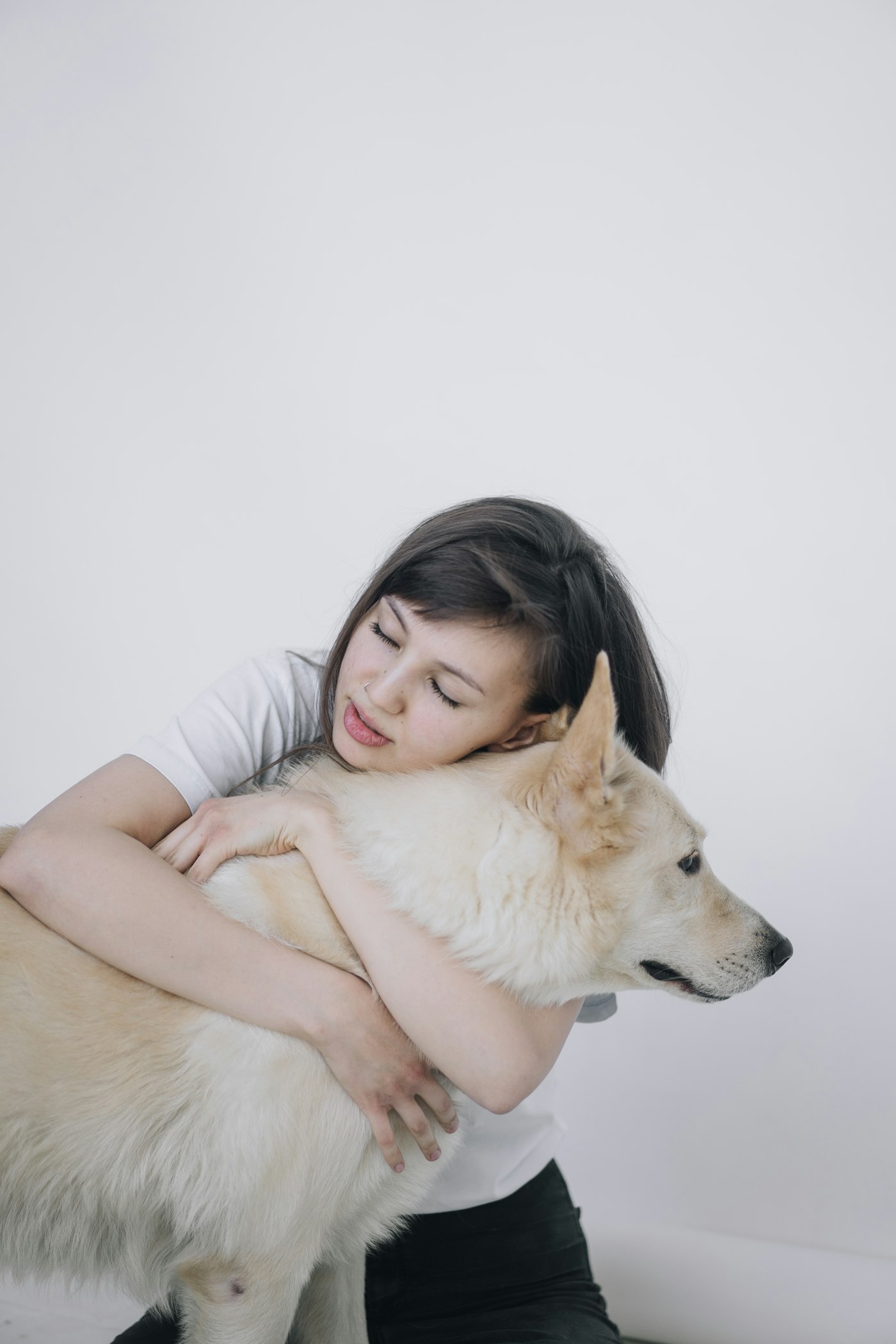 A woman tenderly hugging her dog