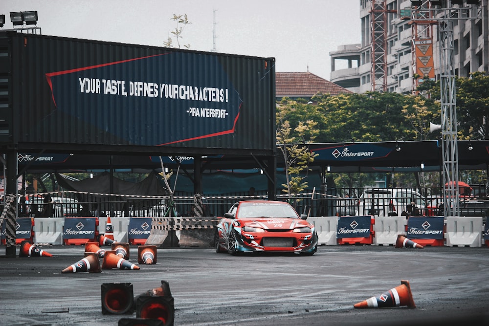 red vehicle parked beside wall