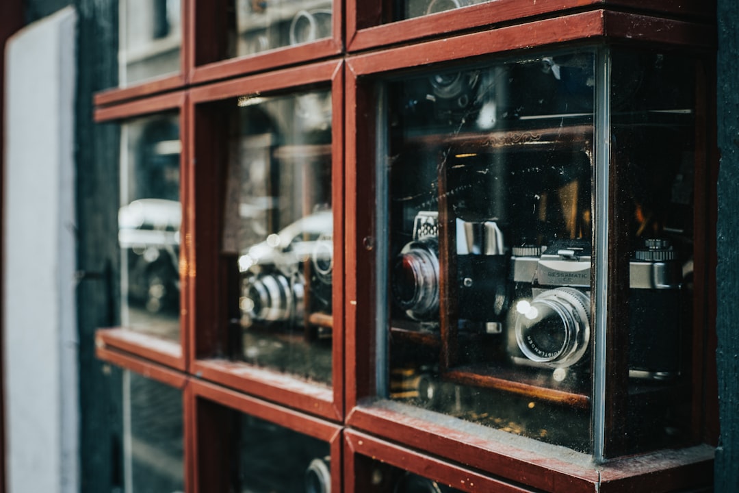 assorted cameras displayed inside glass cases