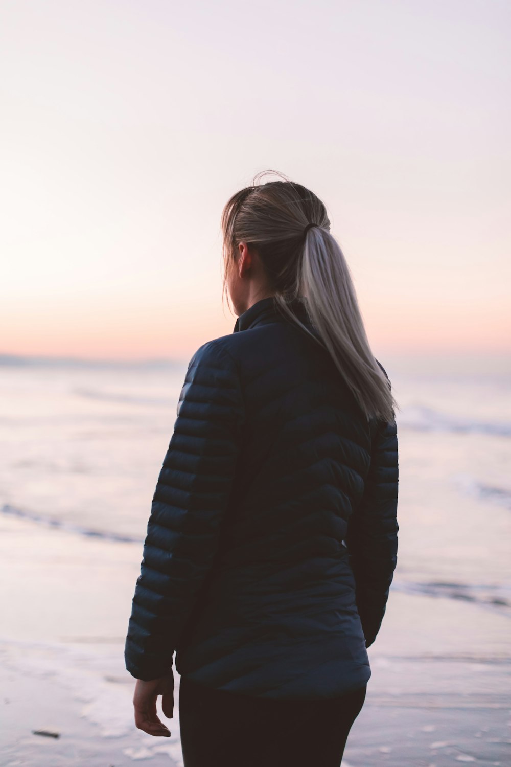 woman standing on shore during daytime