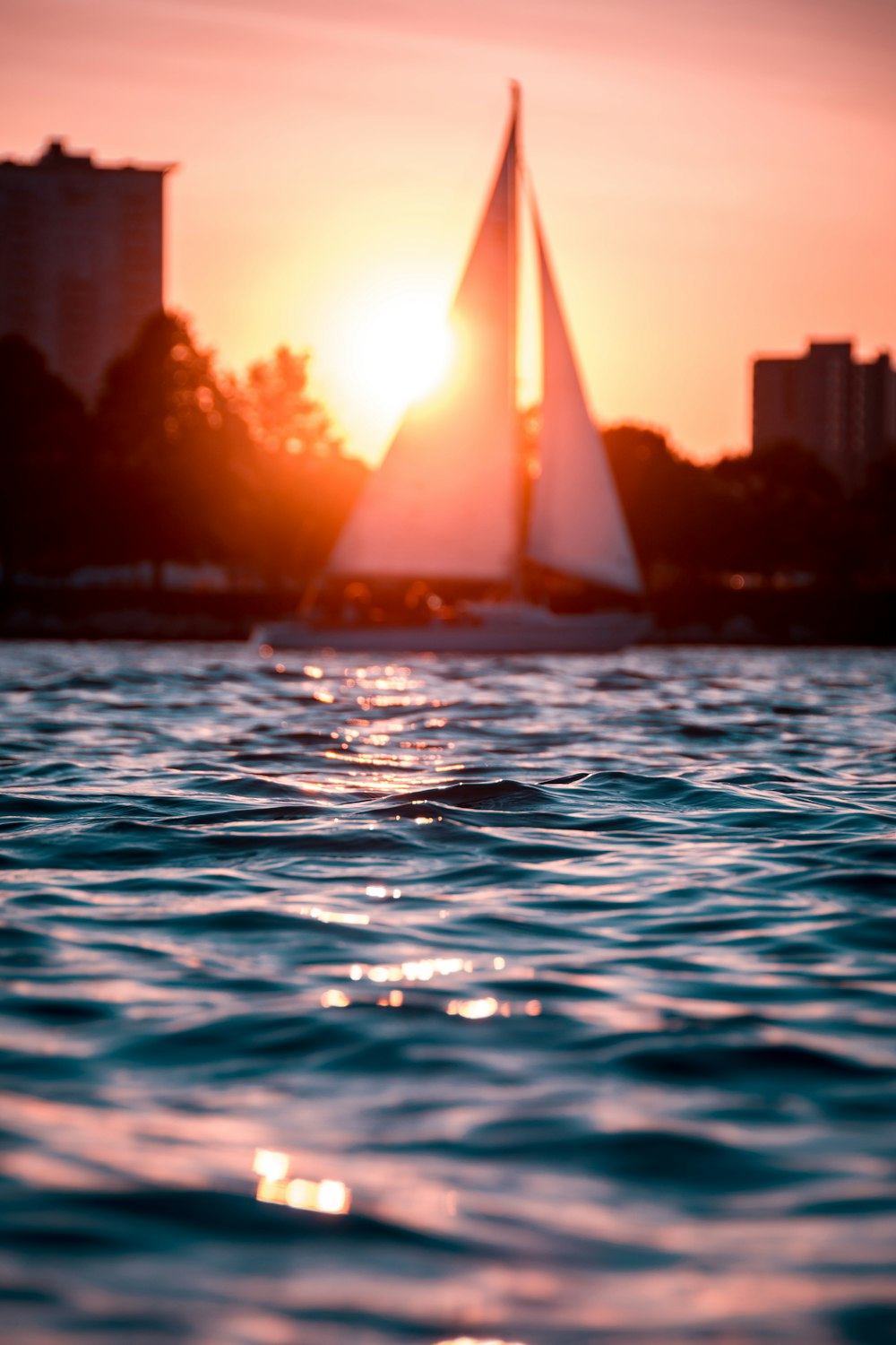 sailing boat on body of water during golden hour