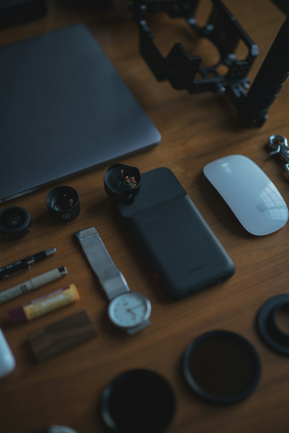 round white analog watch near devices on table