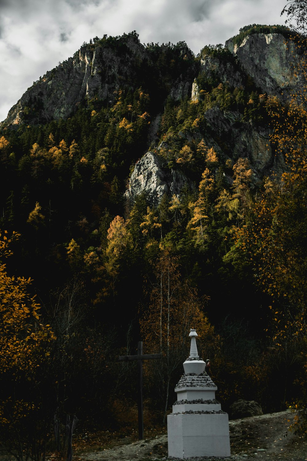 white concrete tower near mountain during daytime