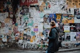 person standing beside wall during daytime