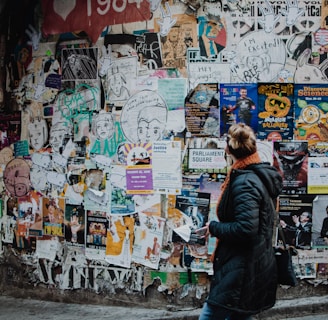 person standing beside wall during daytime