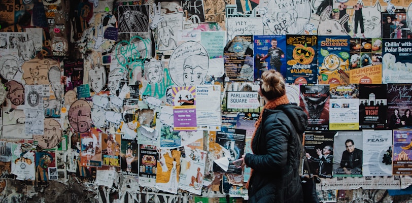 person standing beside wall during daytime