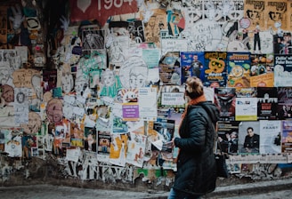 person standing beside wall during daytime