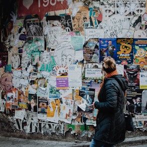 person standing beside wall during daytime