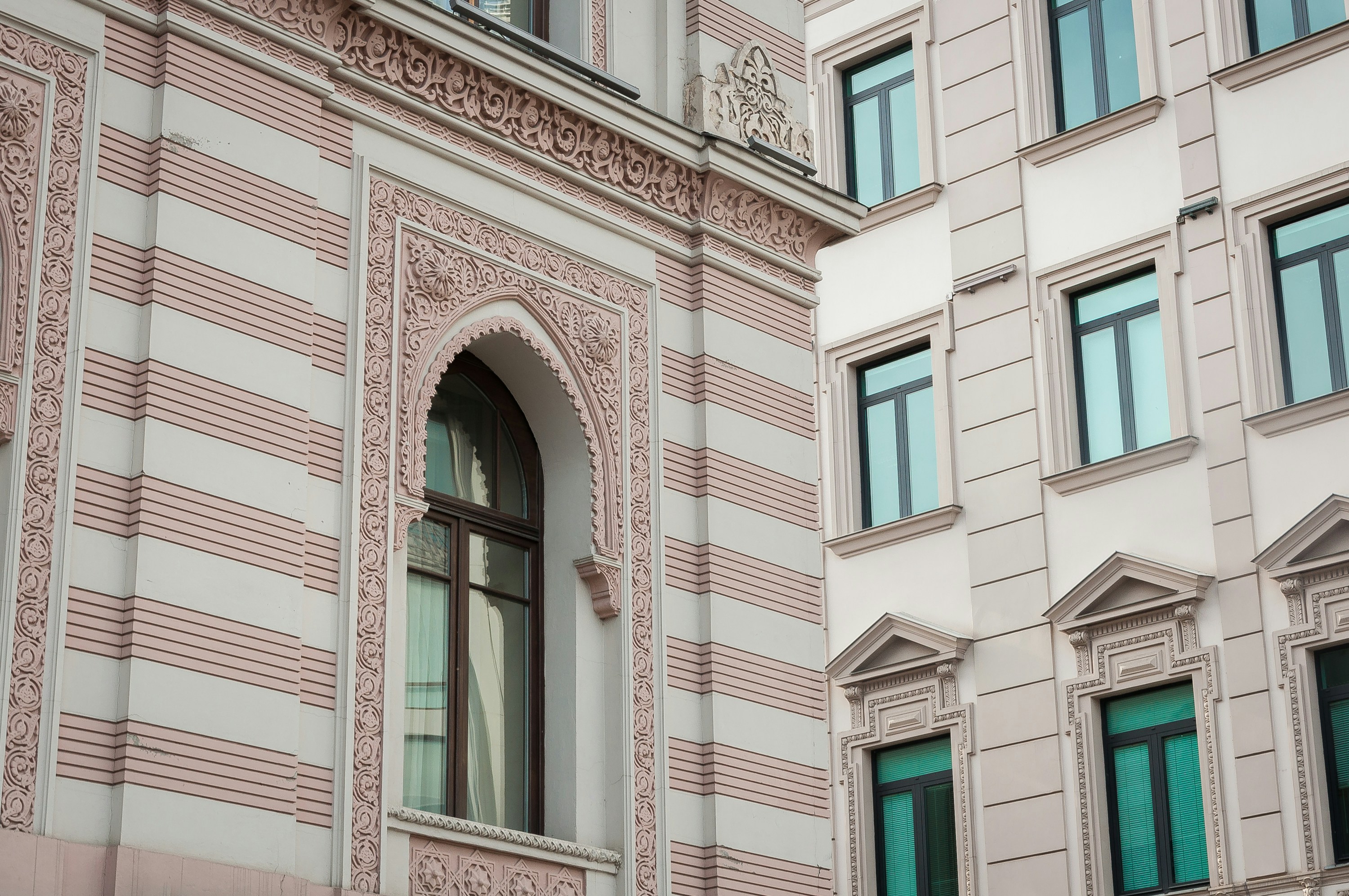 brown and white concrete building with window panel