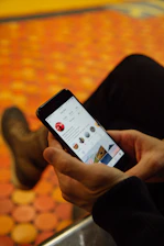 person holding post-2017 iPhone turned-on
