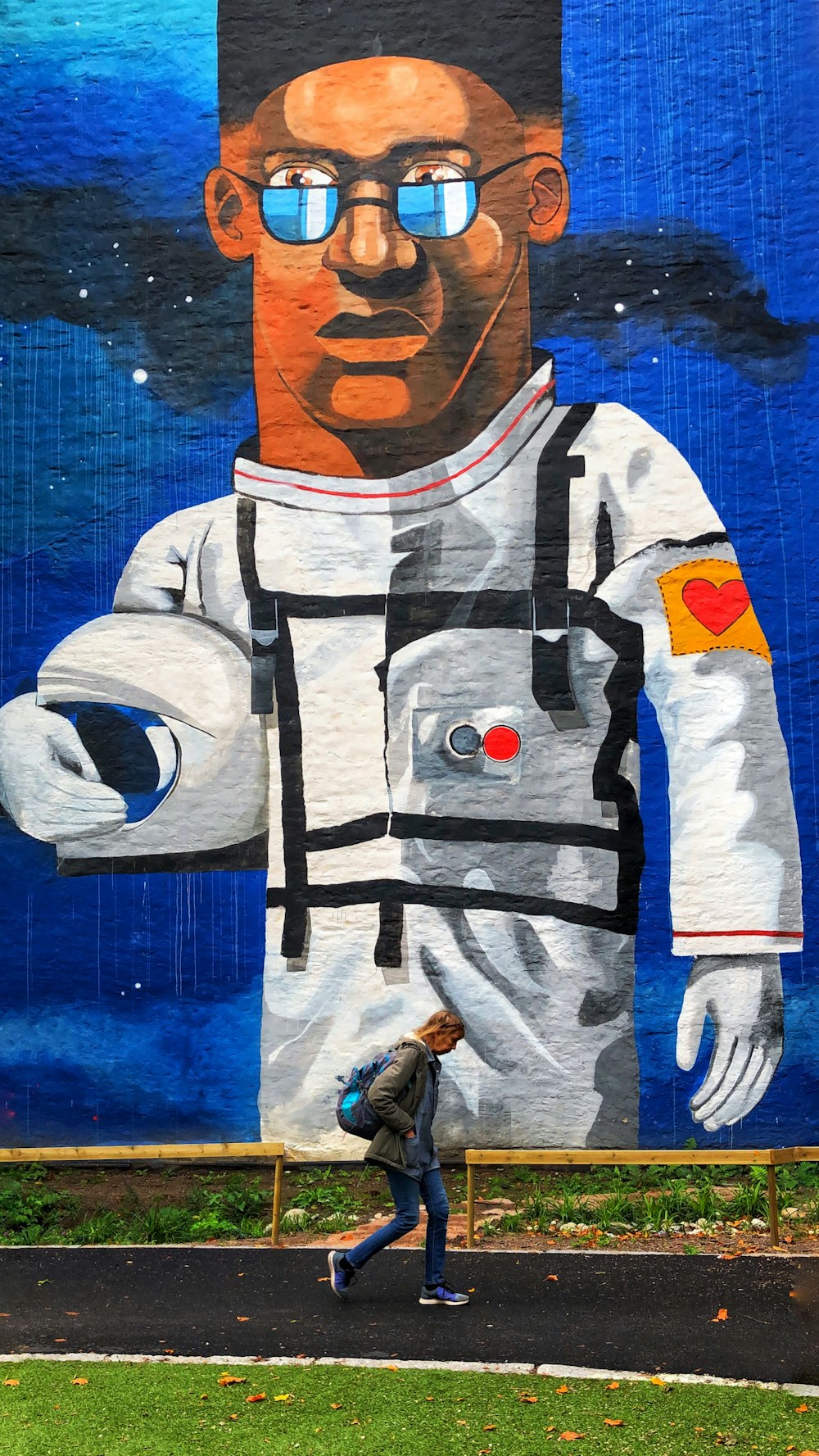 man wearing white astronaut suit painting