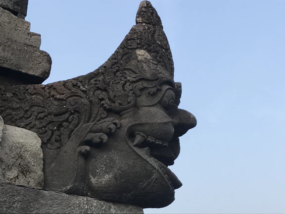 Stone carving replica depicting a mythological creature from pre-Columbian lore.