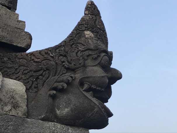 An ancient mythological being sculpture with intricate carvings and mysterious symbols.