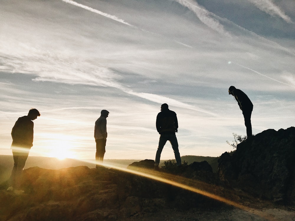 silhouette of four men