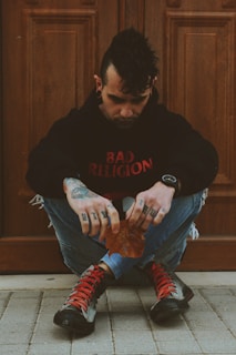 man sitting while holding dry leaf