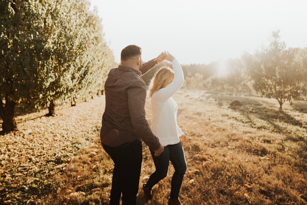 couple dancing near trees