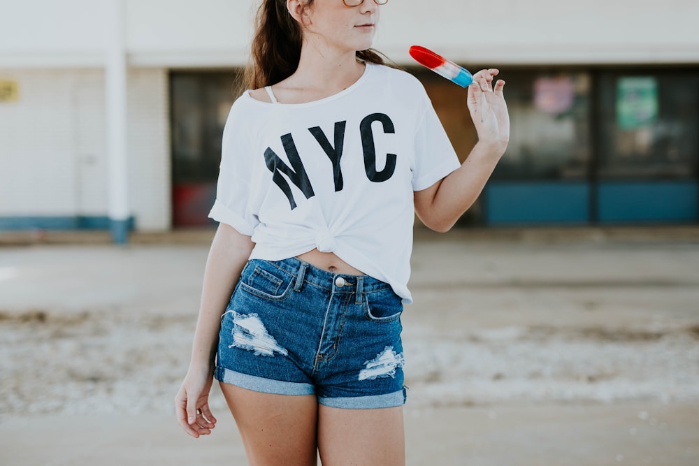 standing woman holding popsicle