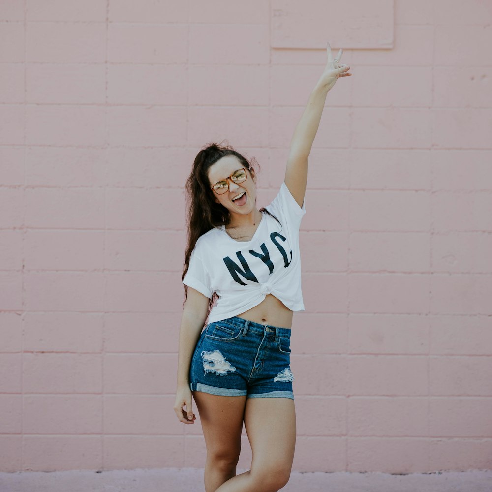 smiling woman doing peace sign