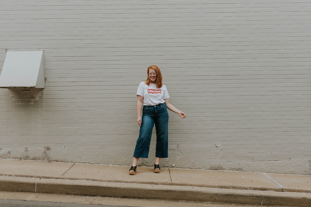 woman standing in front of white wall