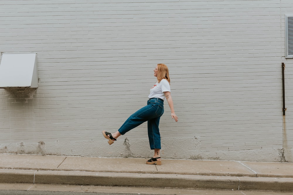 standing woman wearing green pants during daytime