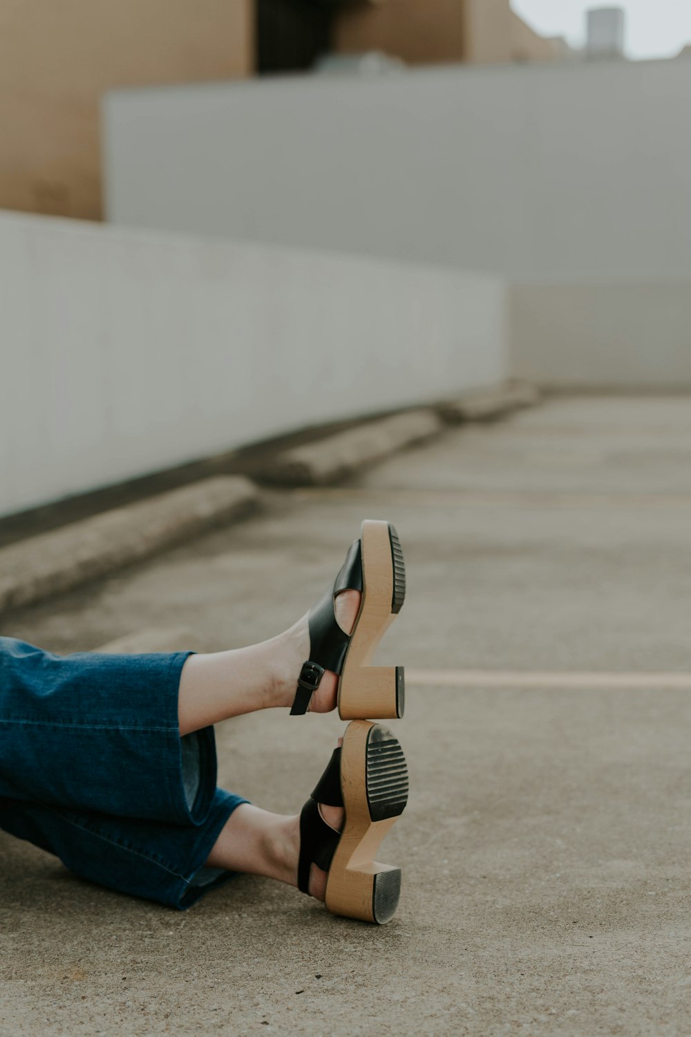 person's feer wearing brown-and-black leather chunky-heeled sandals