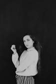 woman wearing white turtleneck sweater in black background