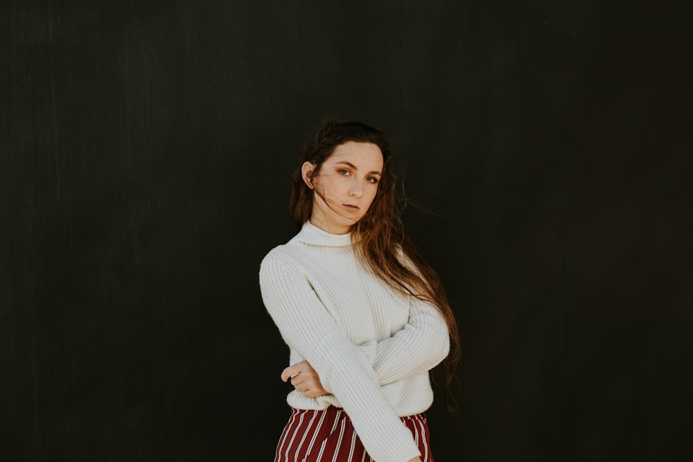 woman wearing white sweater making pose