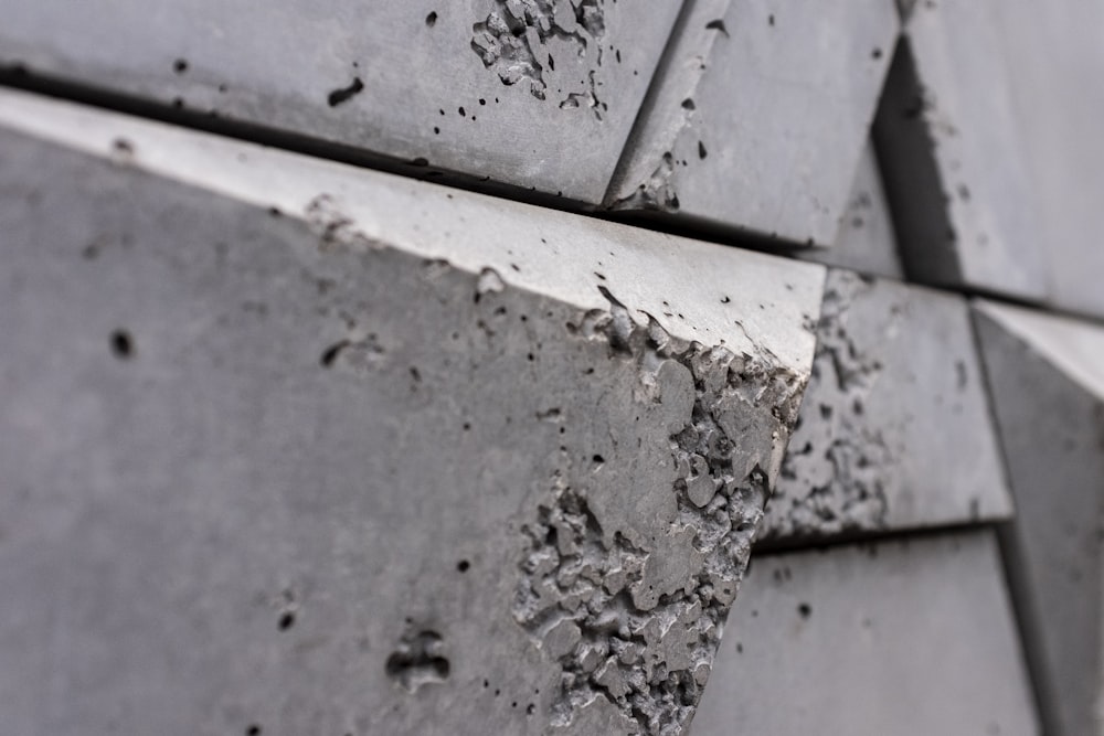 a close up of a cement wall with holes in it