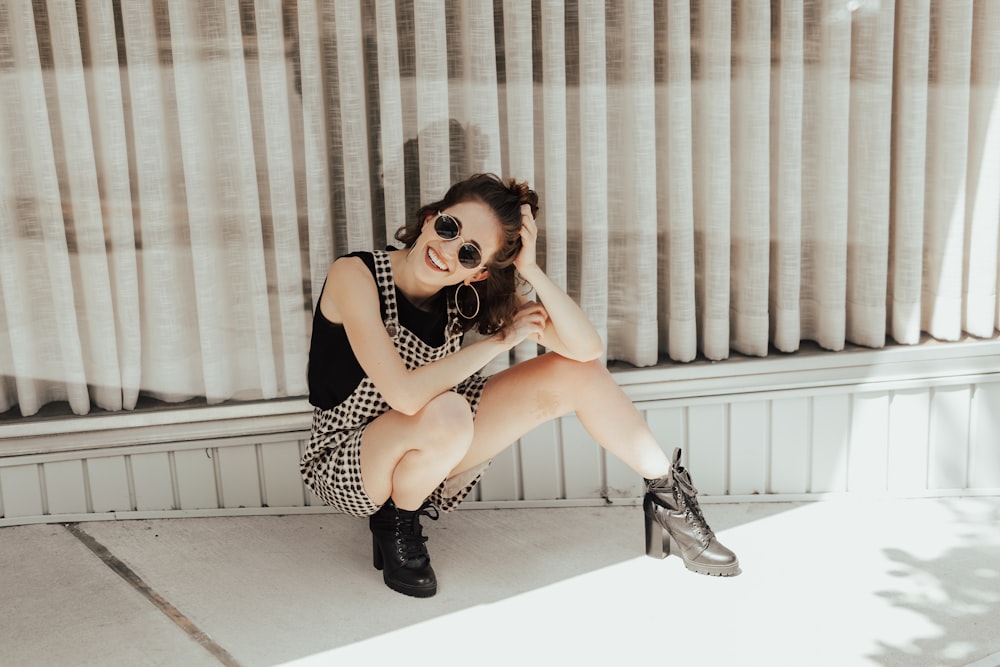 woman sitting beside wall