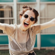 smiling woman raising hands