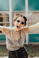 smiling woman raising hands