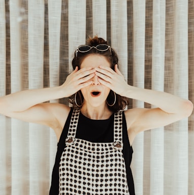 woman covering eyes with hand