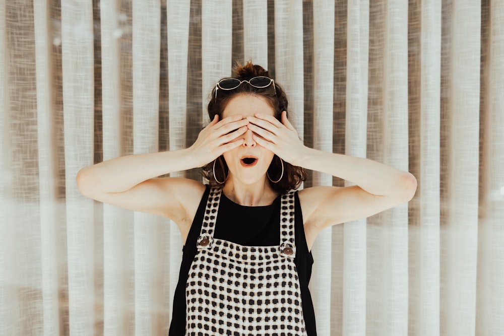 woman covering eyes with hand