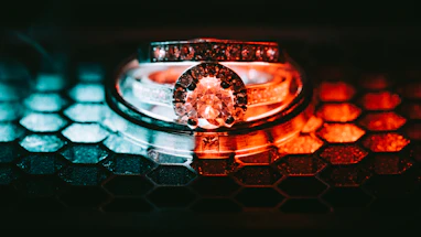 Natural bridal diamonds sparkling under warm golden light, arranged in a hexagonal display.