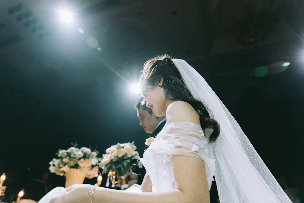 wedding couple near flower arrangements