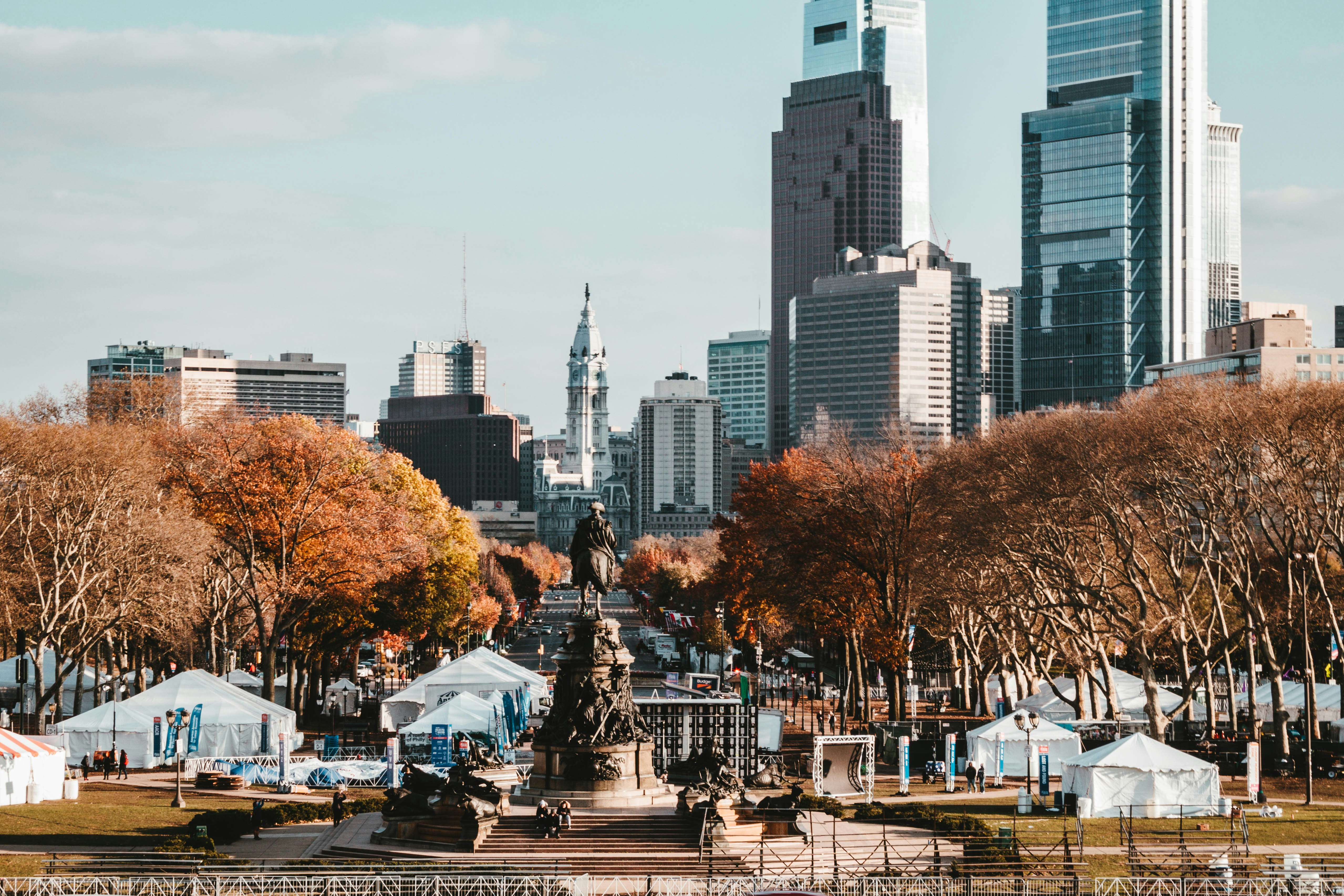 Outdoor event tent setup in a Philadelphia park providing shade for guests