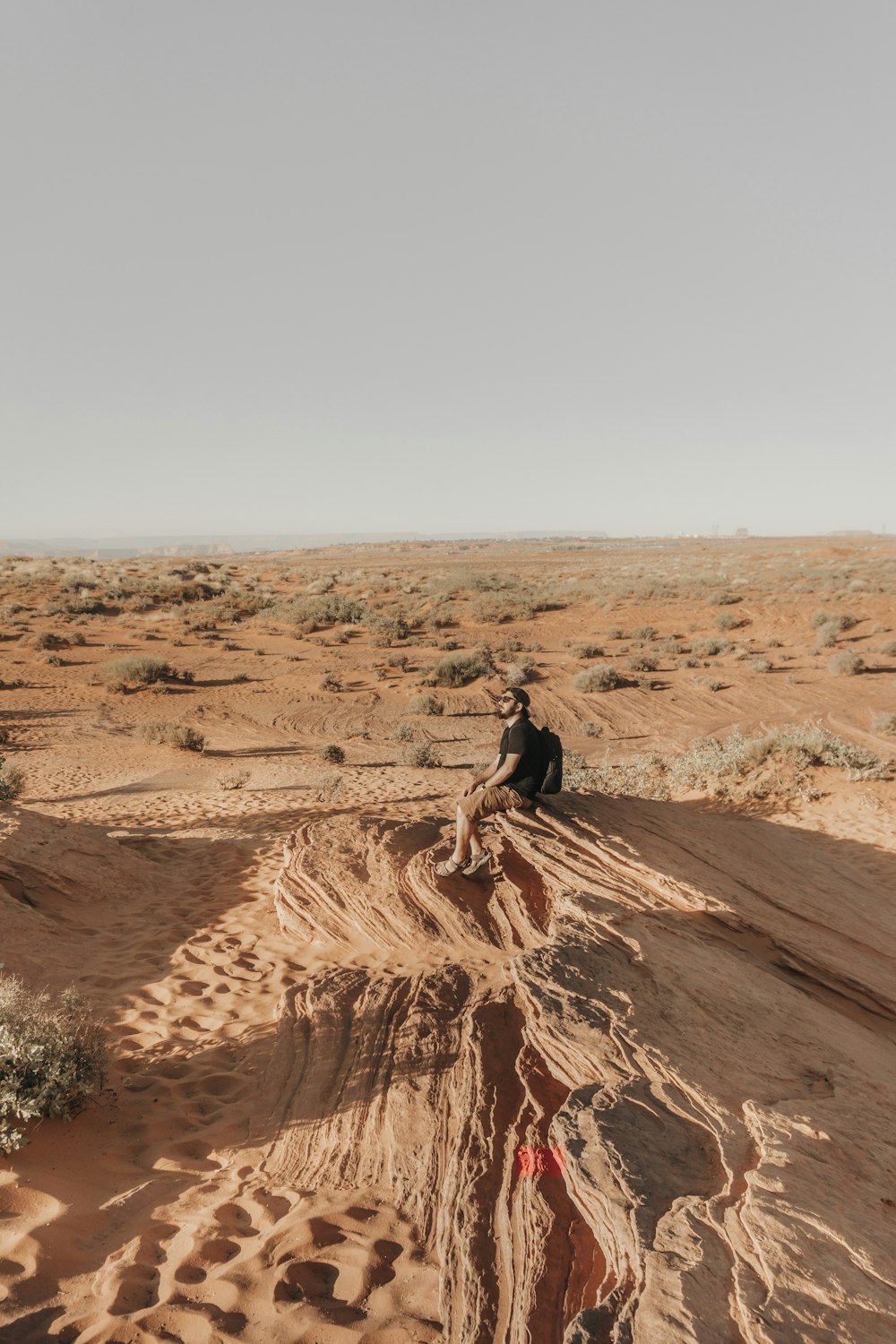 man sitting on brown ground