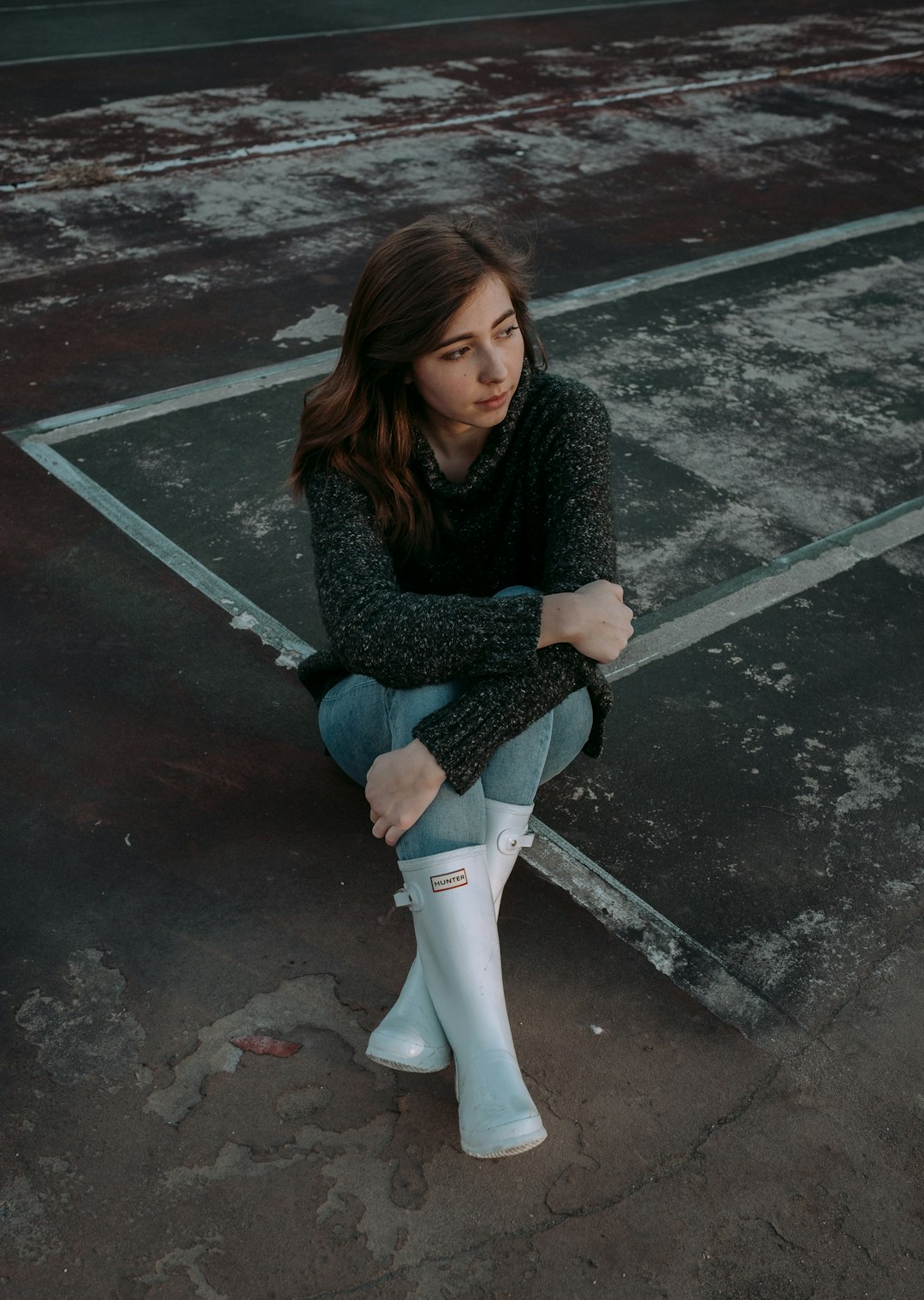 woman in boots sitting on floor