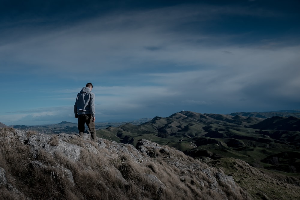 man standing on mountain photo – Free Human Image on Unsplash