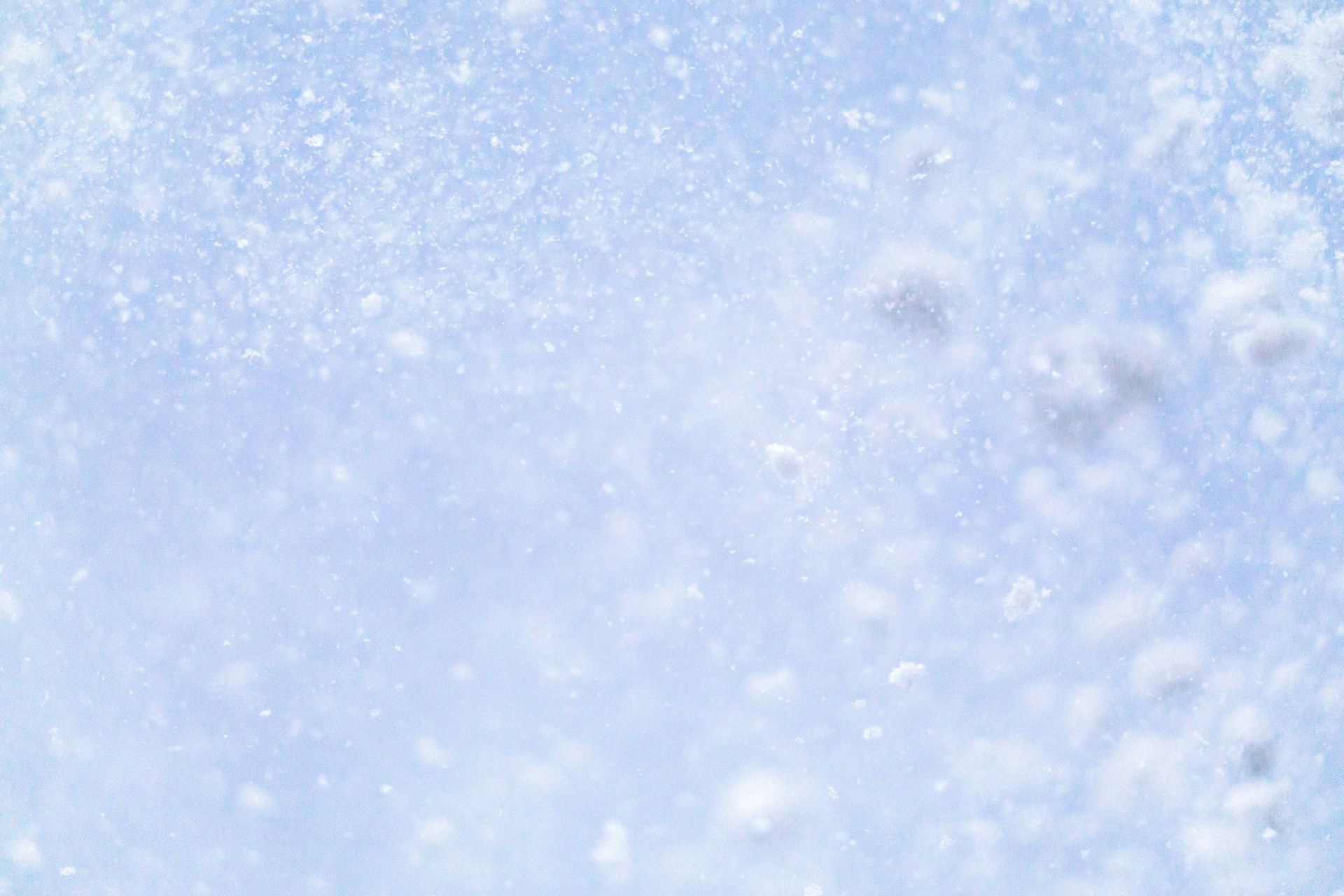 a close up of a snow flakes on a blue sky
