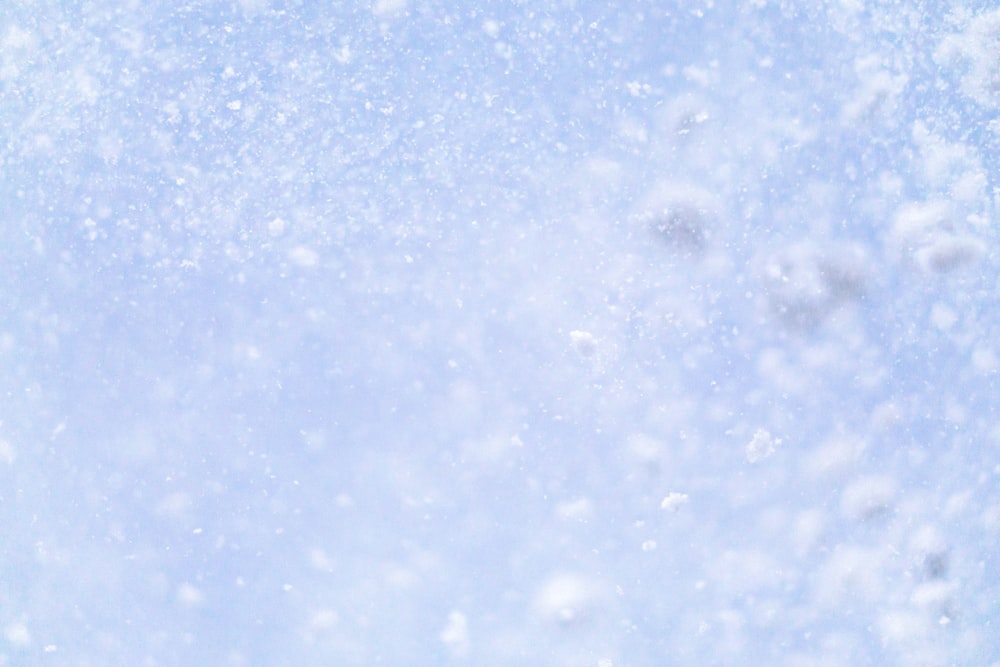 a close up of a snow flakes on a blue sky