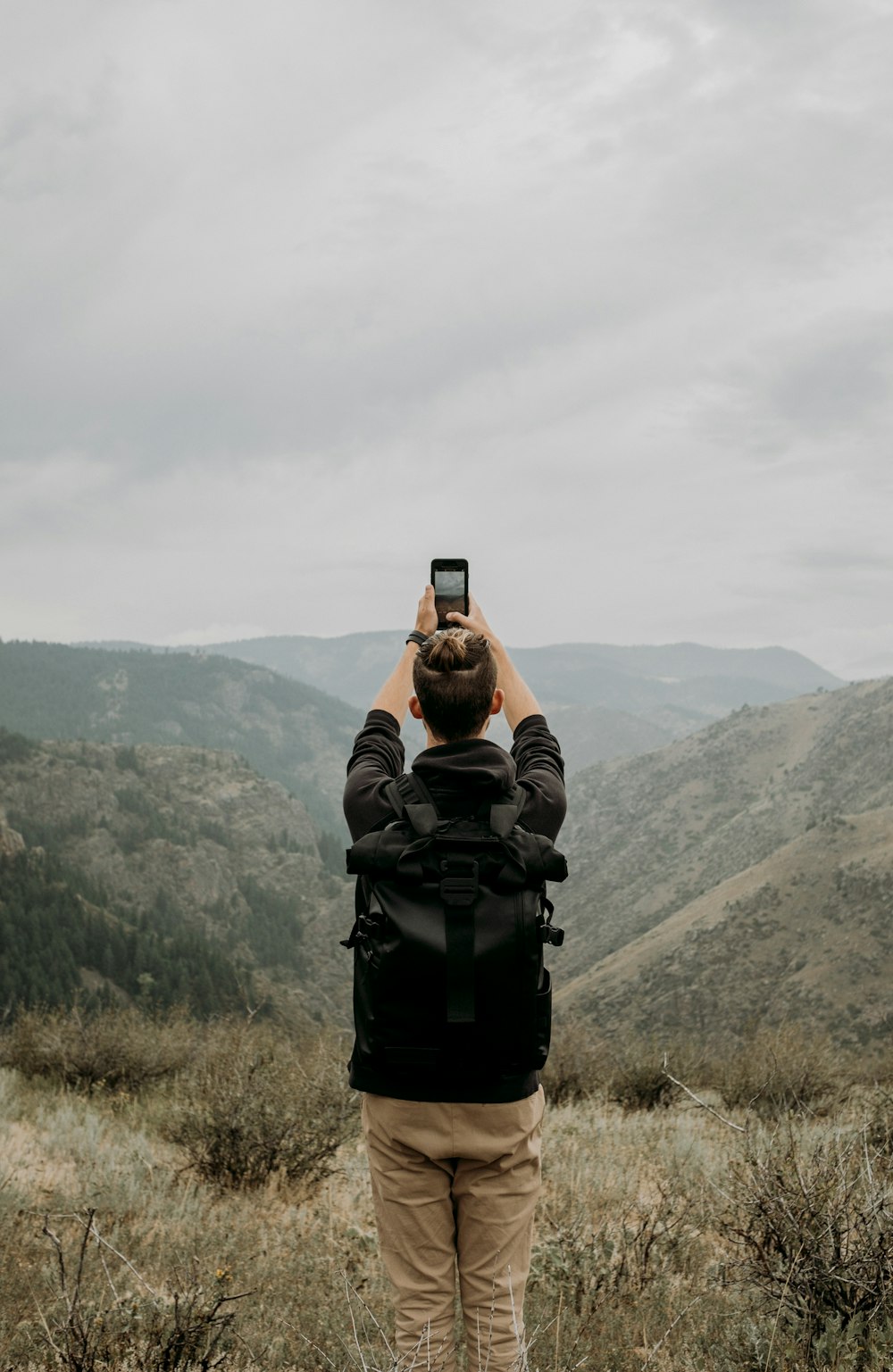 man standing and capturing hills