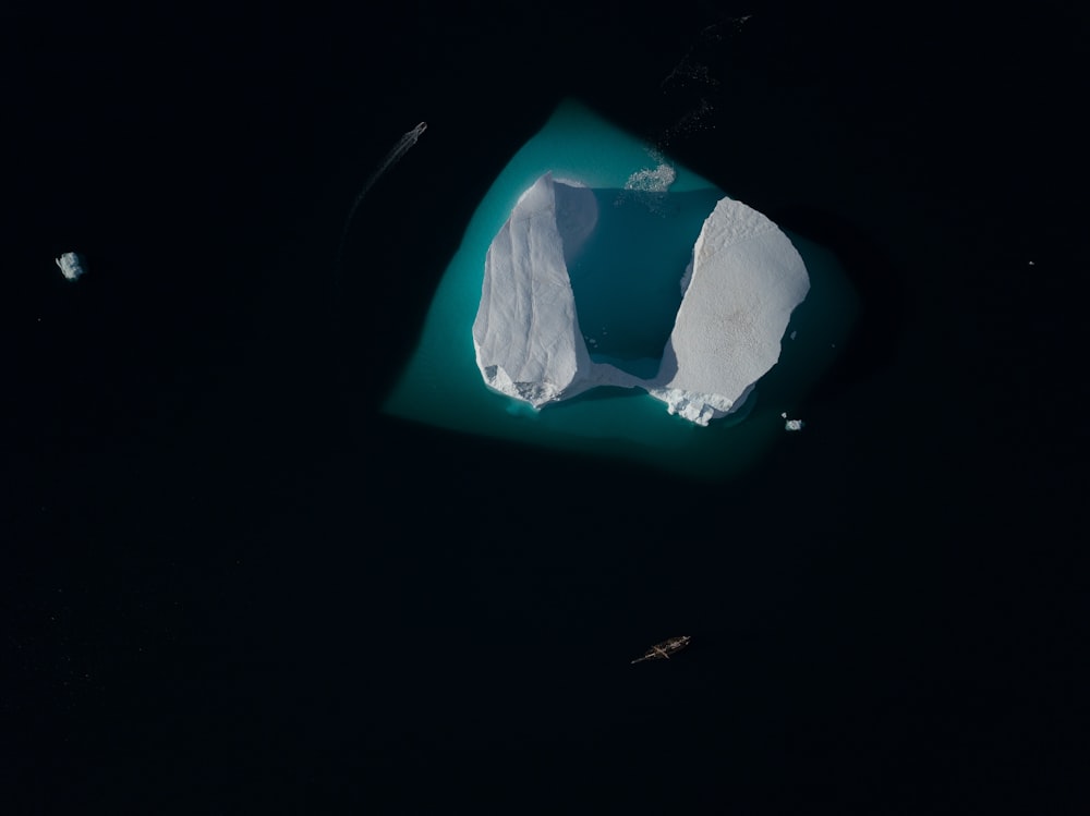 an aerial view of an iceberg in the water