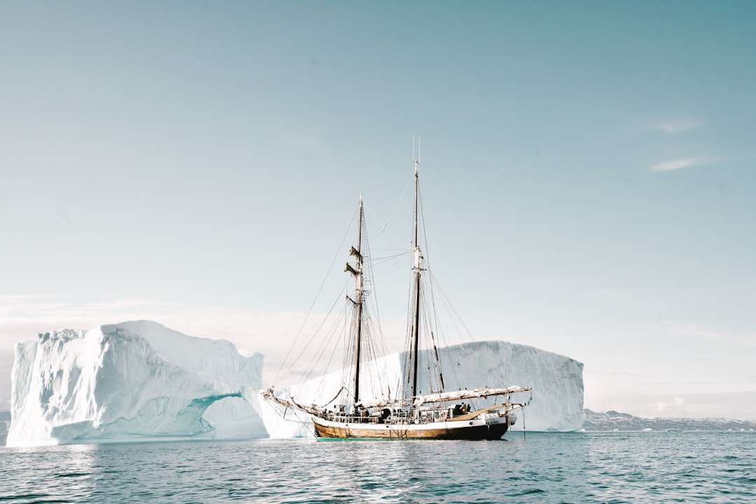 boat approaching iceberg,